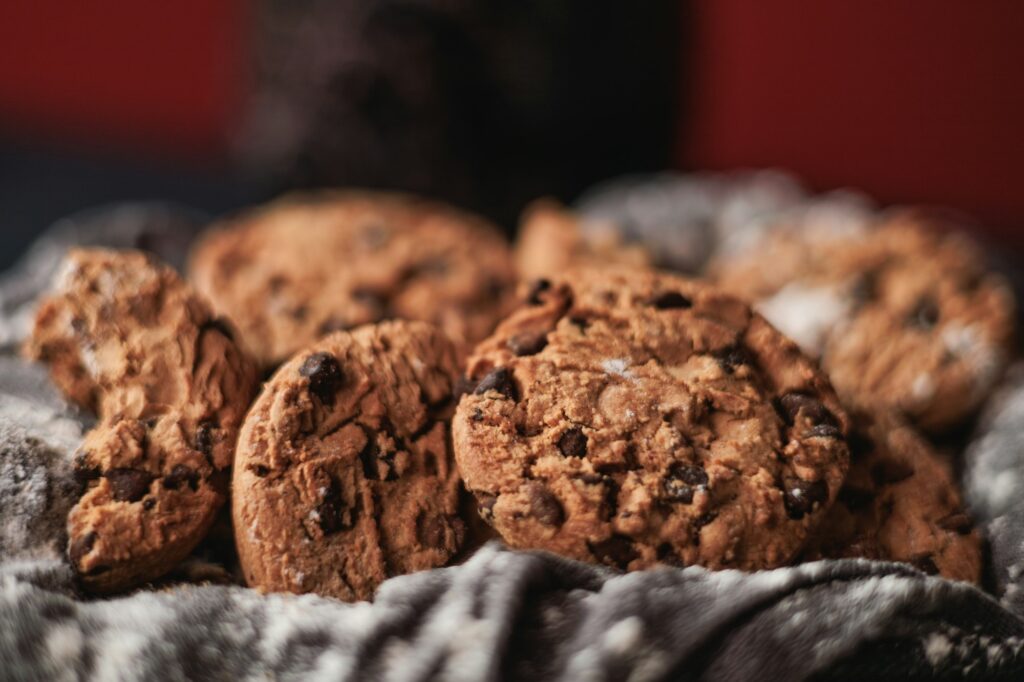 Chocolate chip cookies on red background and white napkin. Big close up view